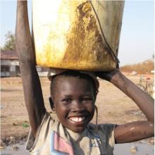 Girl getting water in Rumbek. Photo: Caroline Gluck