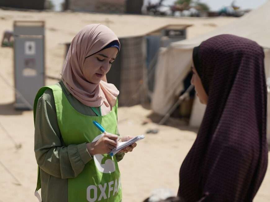 Oxfam worker collecting stories from displaced woman in Gaza