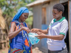 Two women going through sanitary kit