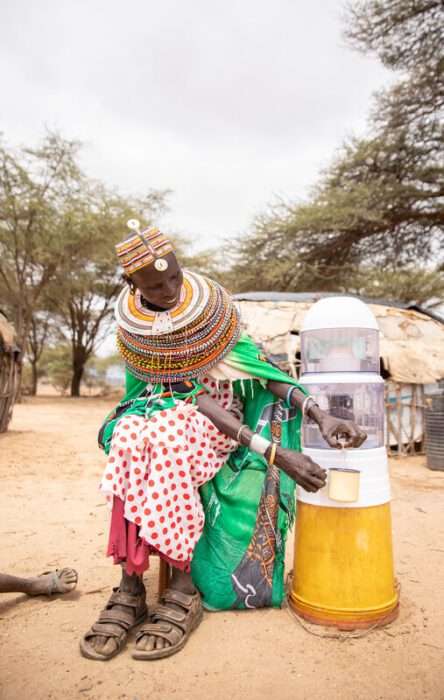 Woman pouring water into her cup