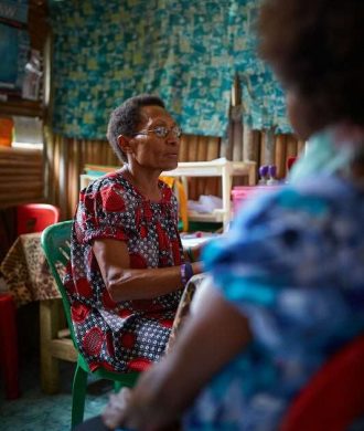 PNG woman typing on computer